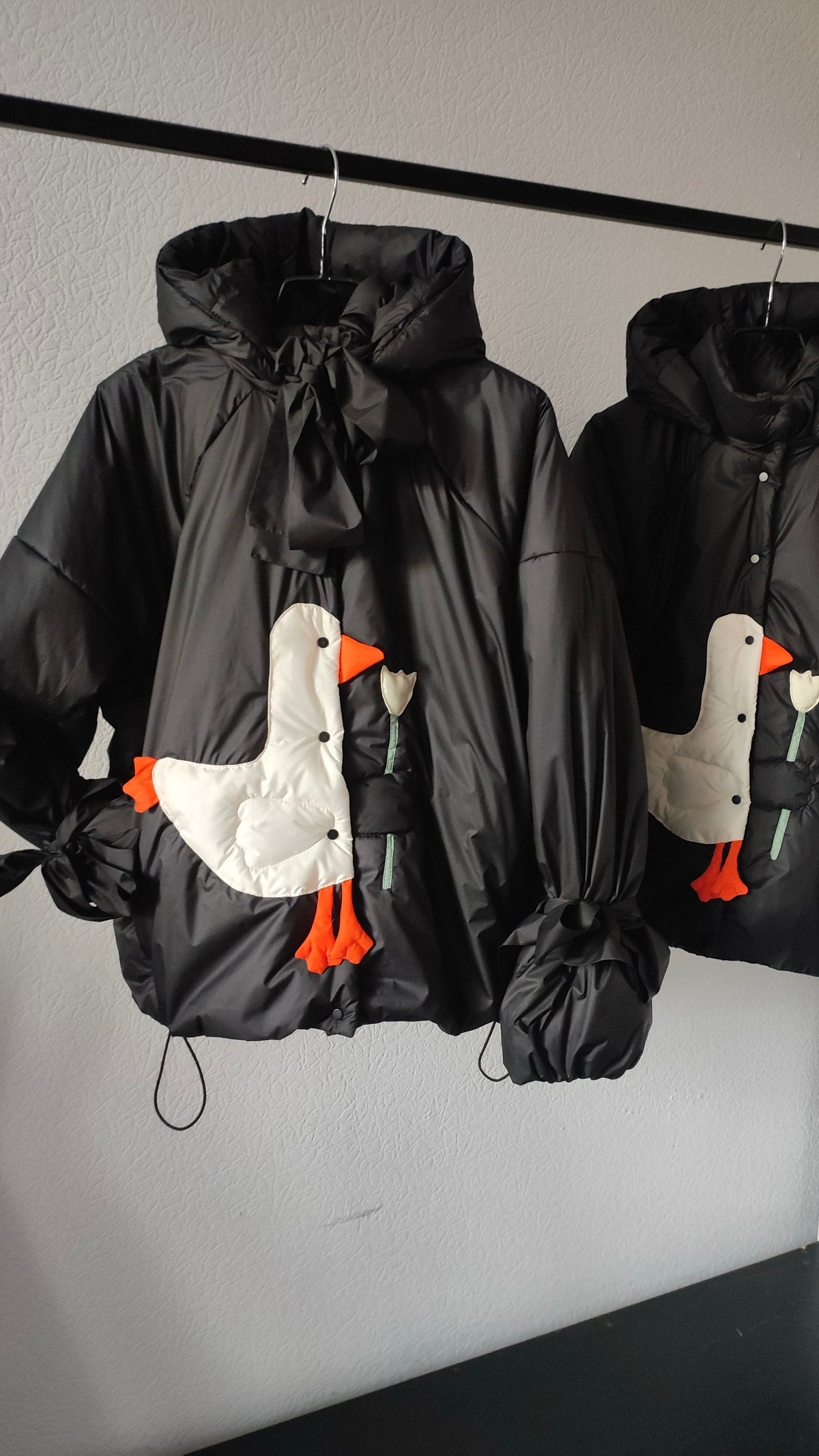 Down jacket  "Little duck" in black with detachable bows and removable hood