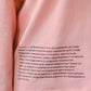 Longsleeve with a symbolic inscription «Human» peach
