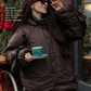 Down jacket in black with detachable chocolate and removable hood